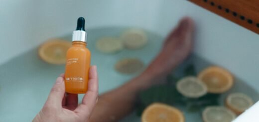 A woman holding a vitamin C serum