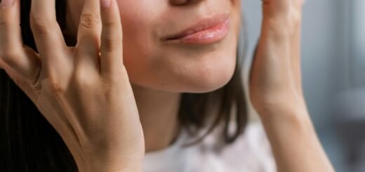 A woman applying eye cream