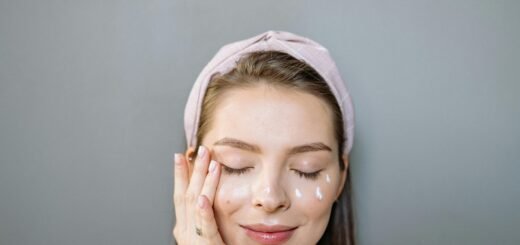 A woman applying eye cream