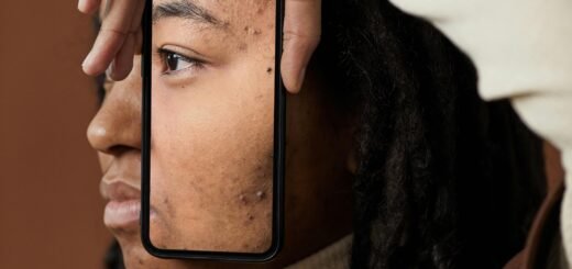 A woman holding a phone showing her face